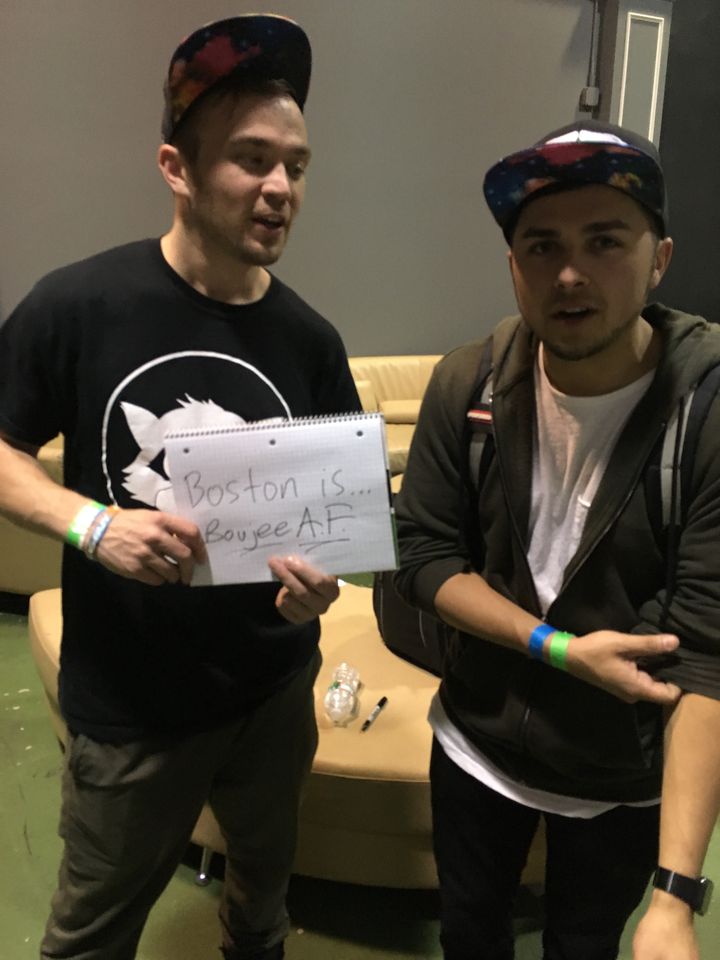 Dude ‘N Guy holding a notepad: Boston is… Boujee A.F.
